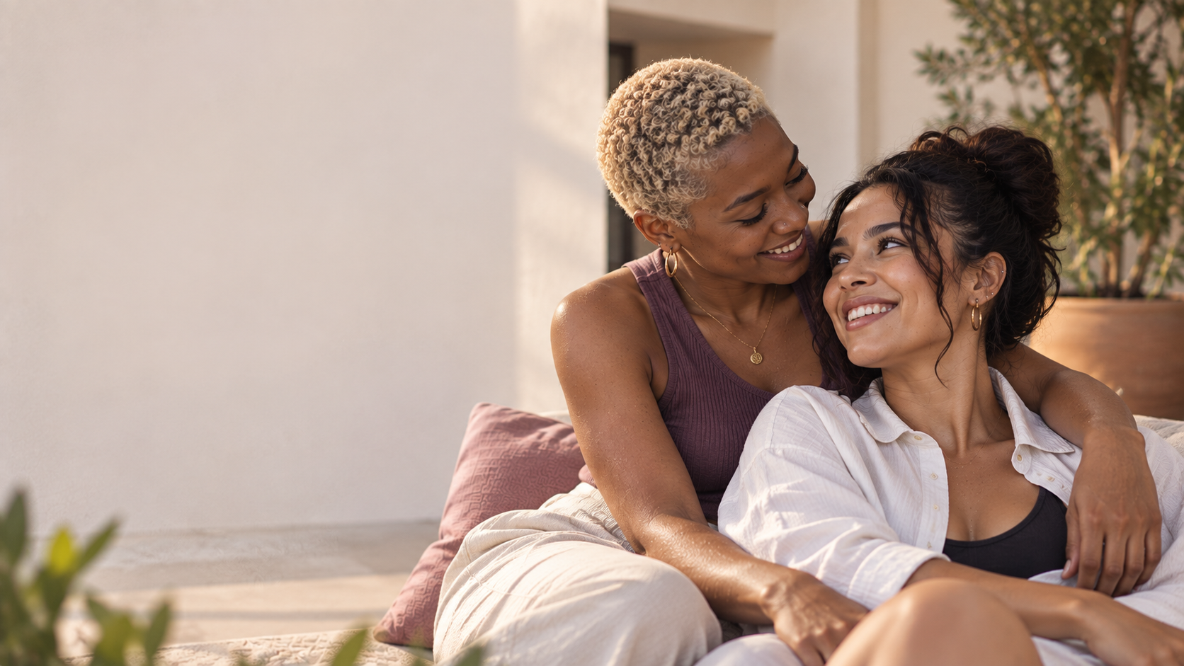 Two women embracing on a sofa